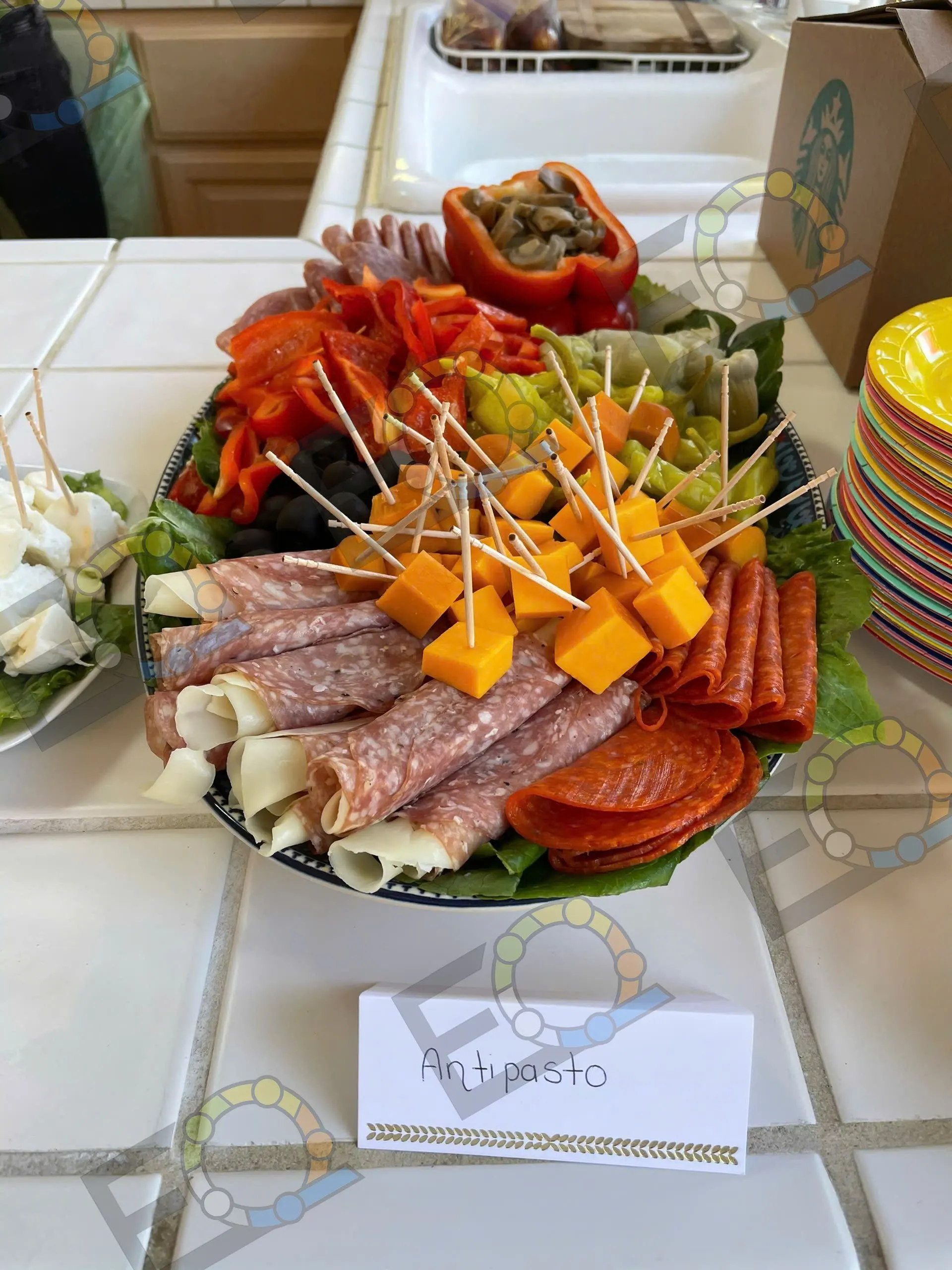 An antipasto board of cured meats, cheese and peppers