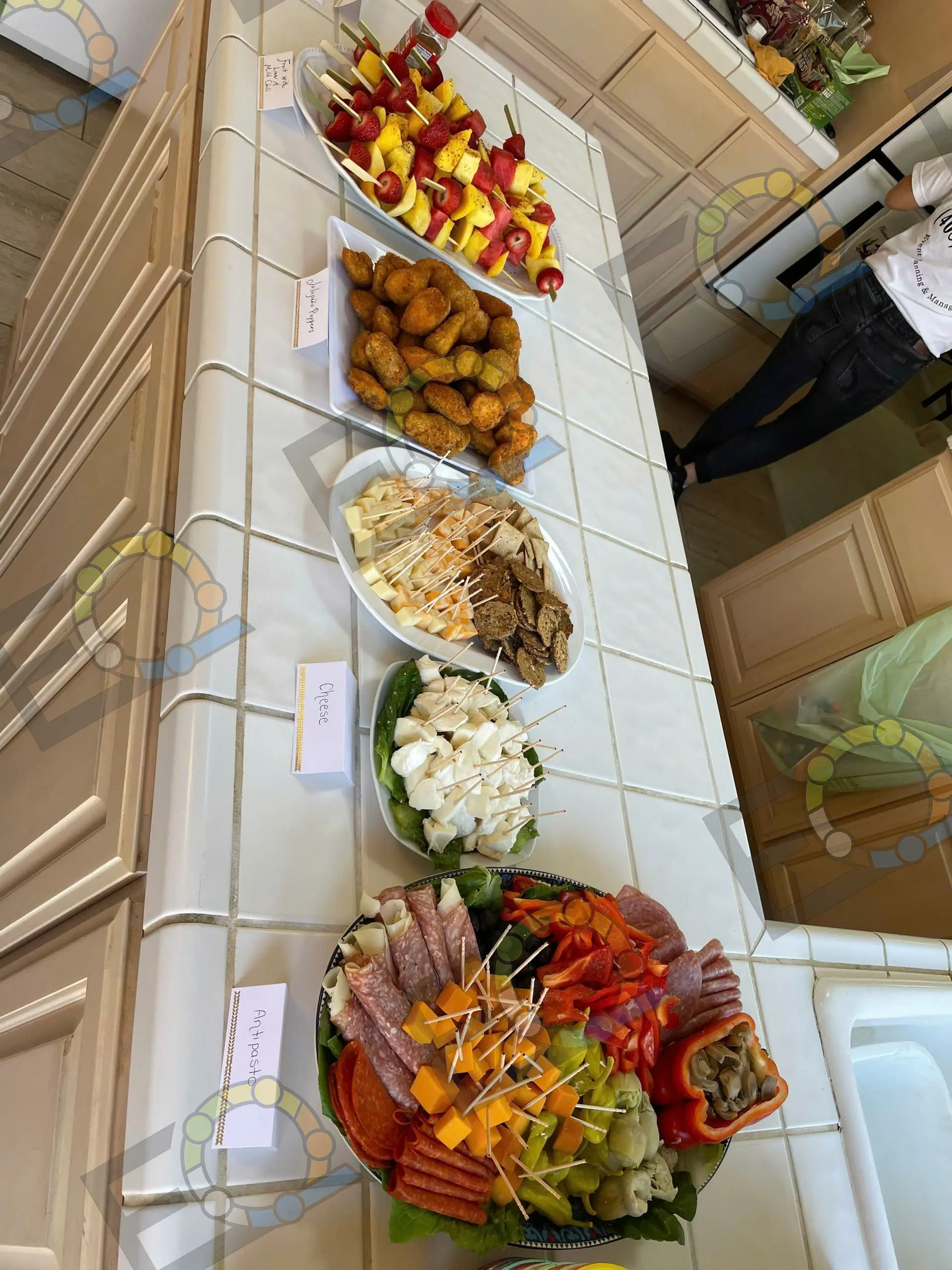 Bowls and platters of appetisers laid along a counter
