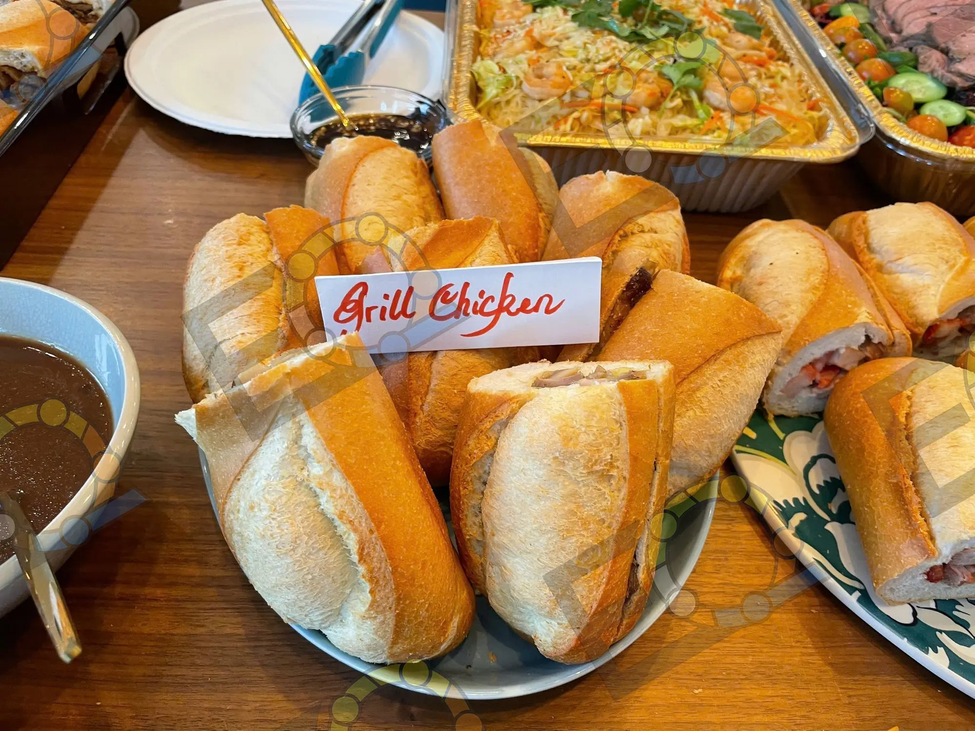 Grilled chicken banh mi labelled on a buffet