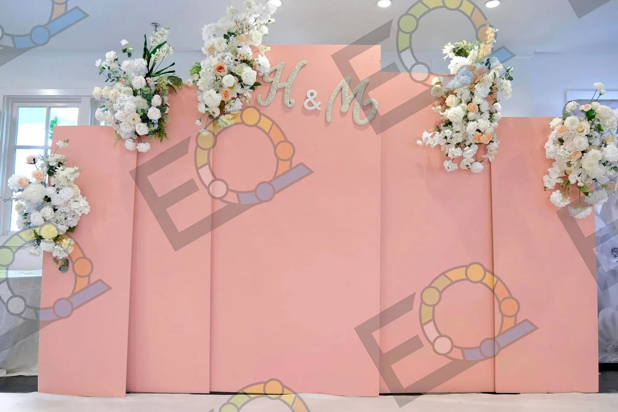 Blush monogram backdrop with white florals