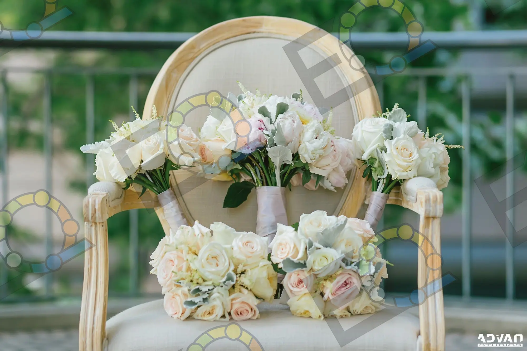 Bridesmaids' bouquets resting on a cane-backed chair
