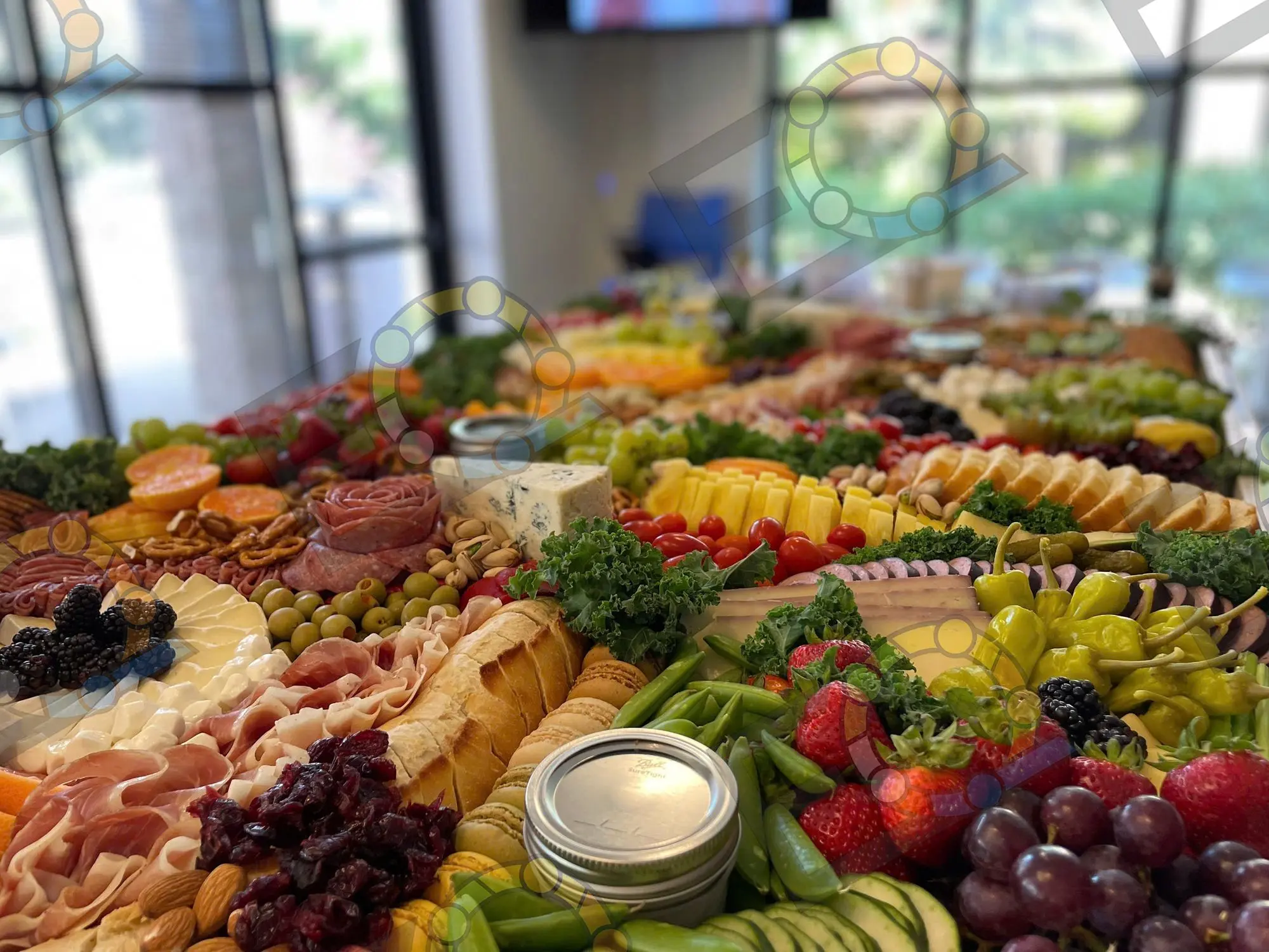 A long grazing table laid out beside a window before guests arrive