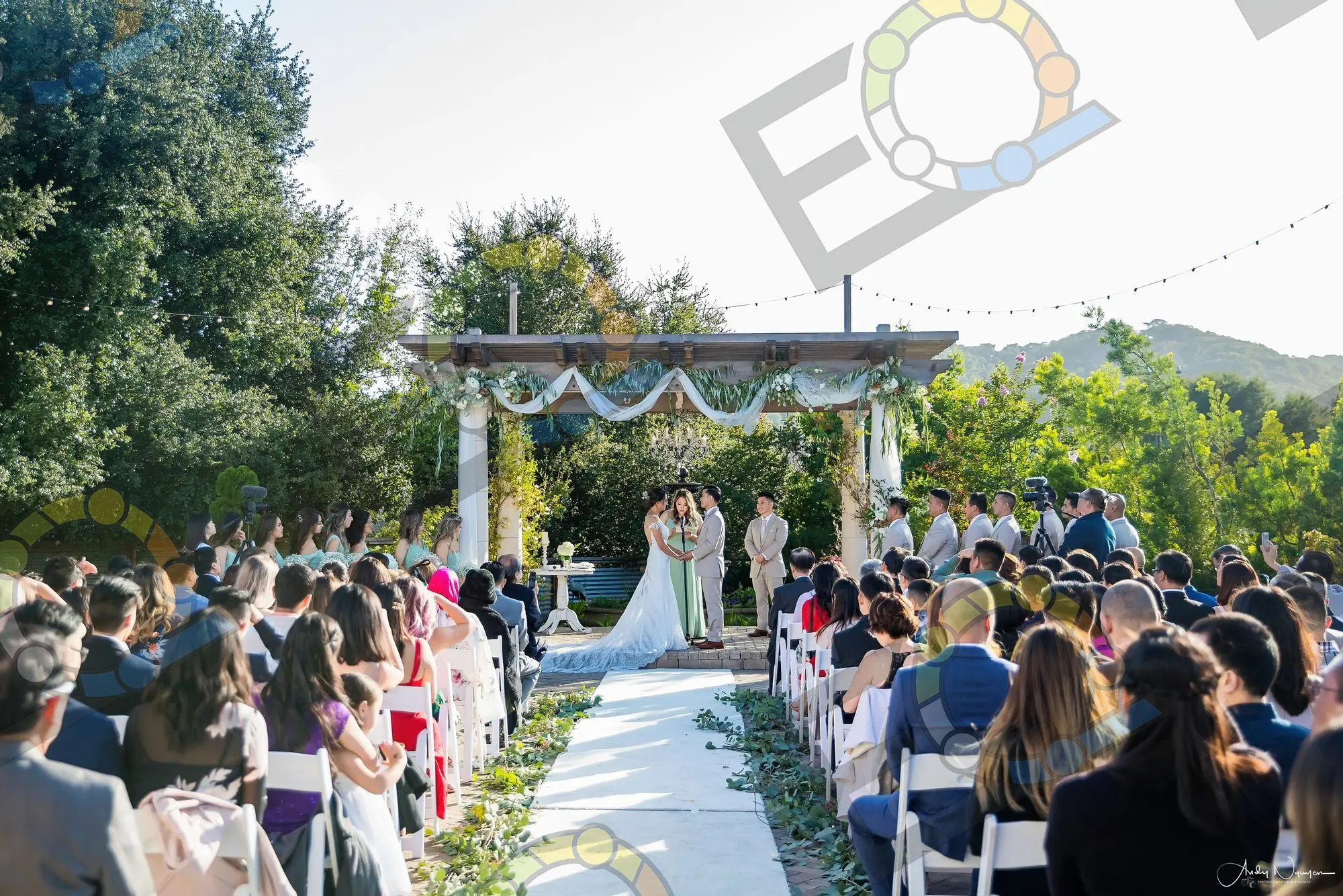Guests seated along an aisle at an outdoor ceremony