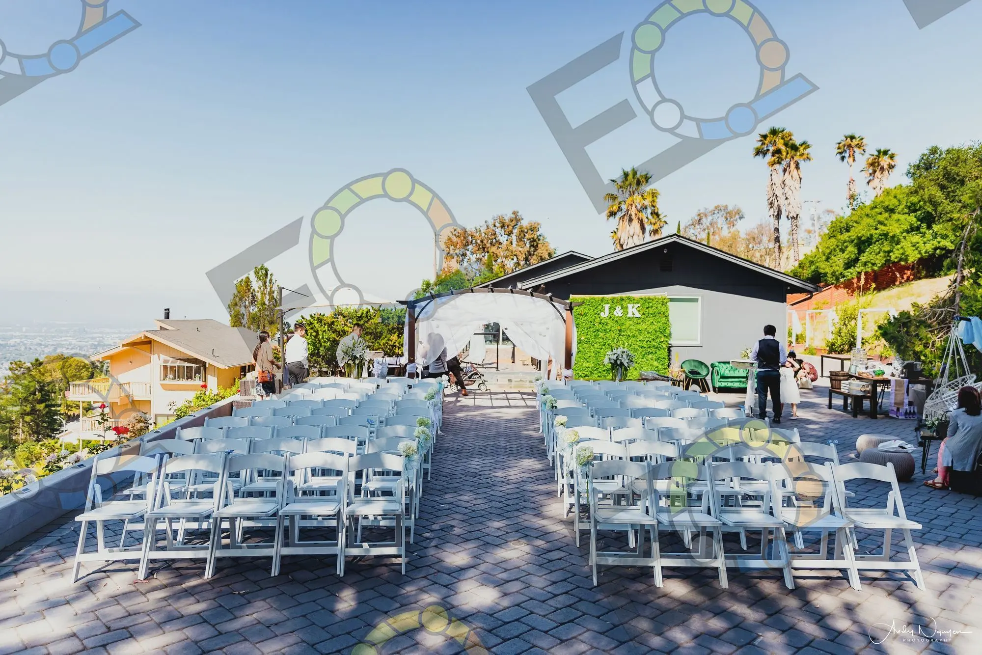 Rows of white ceremony chairs set in a courtyard