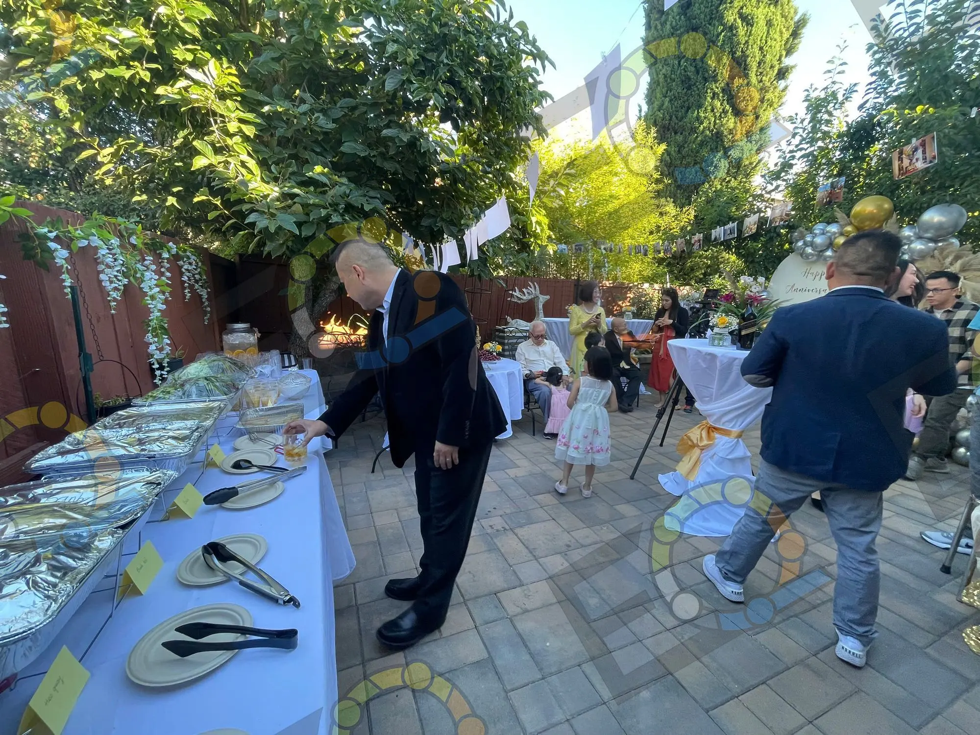 Guests serving themselves at a courtyard buffet