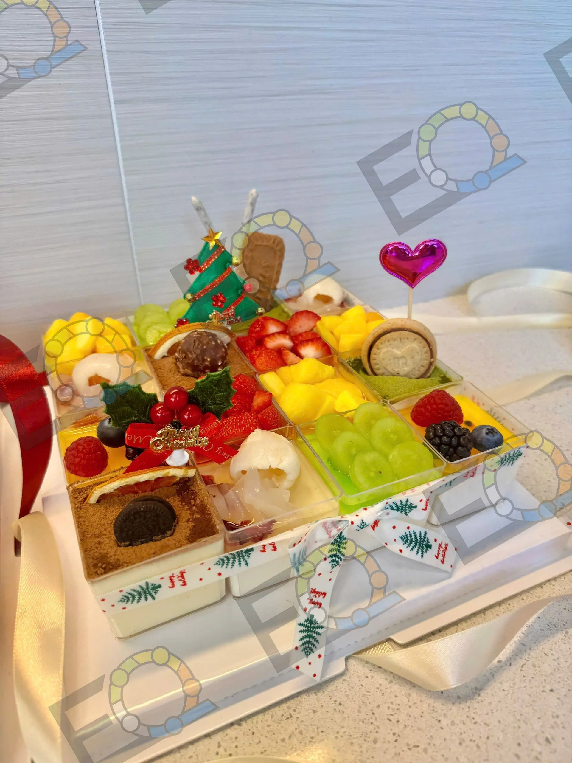 A dessert box of fruit and sweets for a holiday party