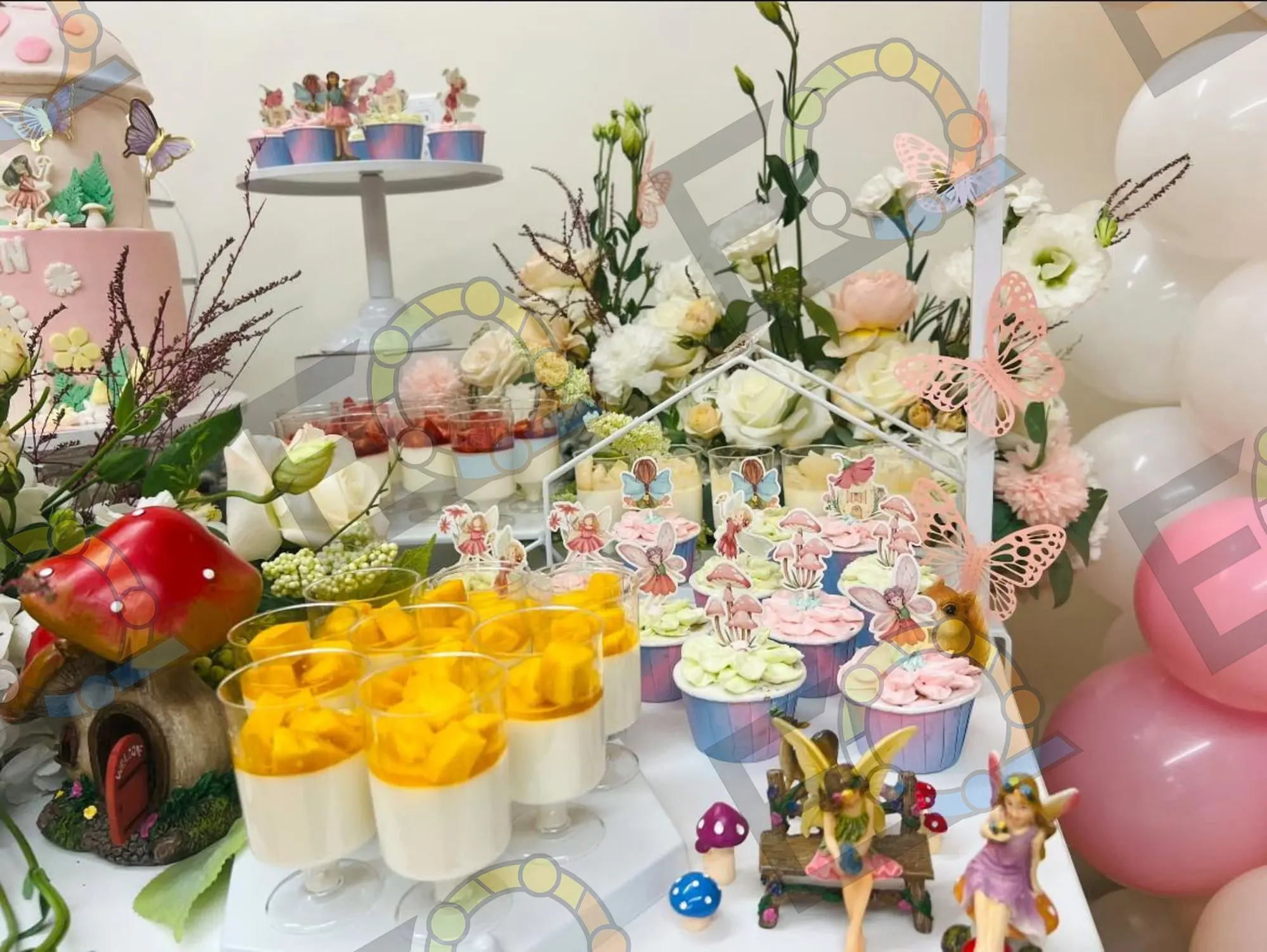 Fairy themed dessert table with florals and toppers