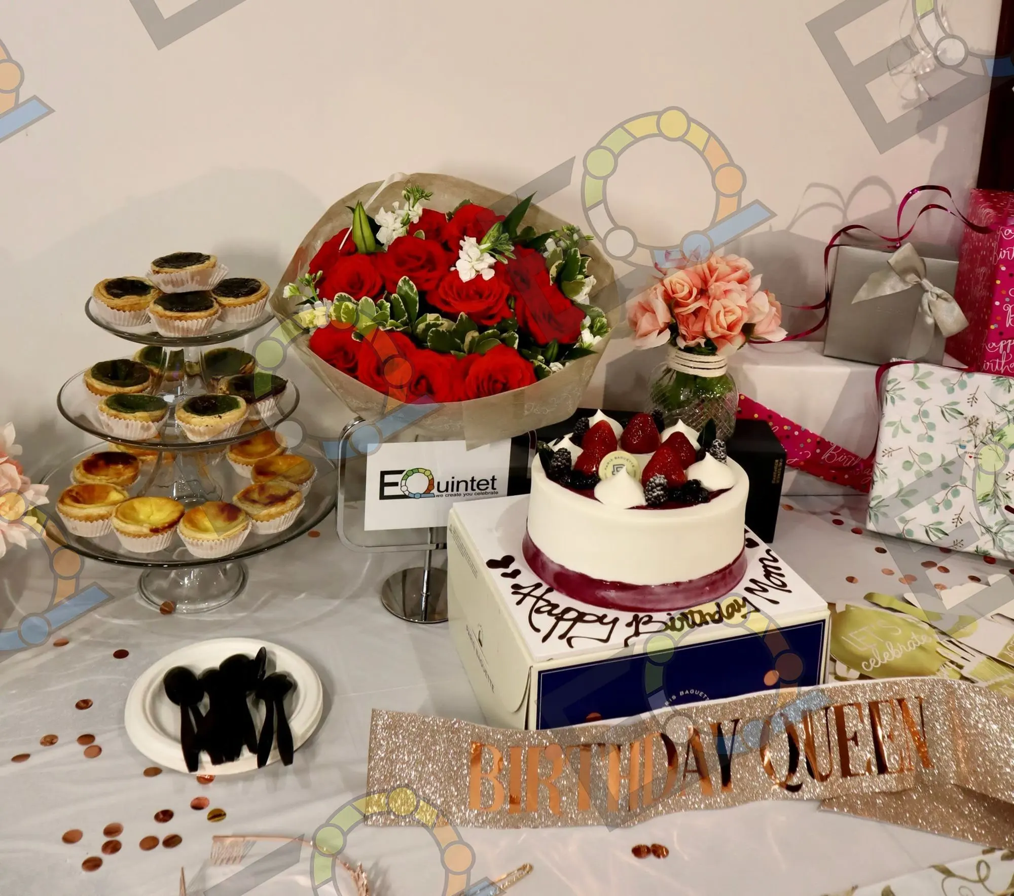 Dessert display with cake, tarts and roses