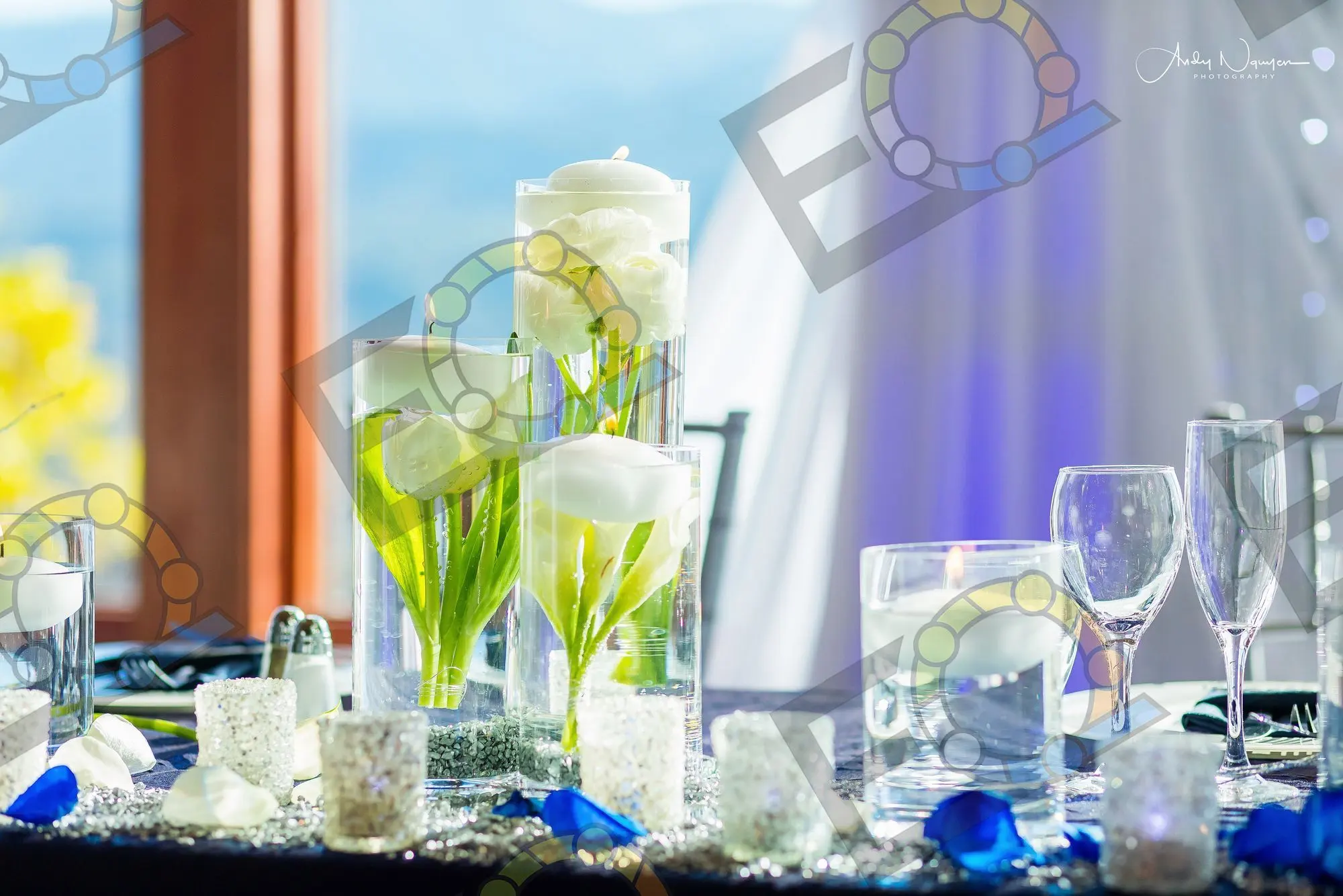 Floating candles and calla lilies in tall glass cylinders