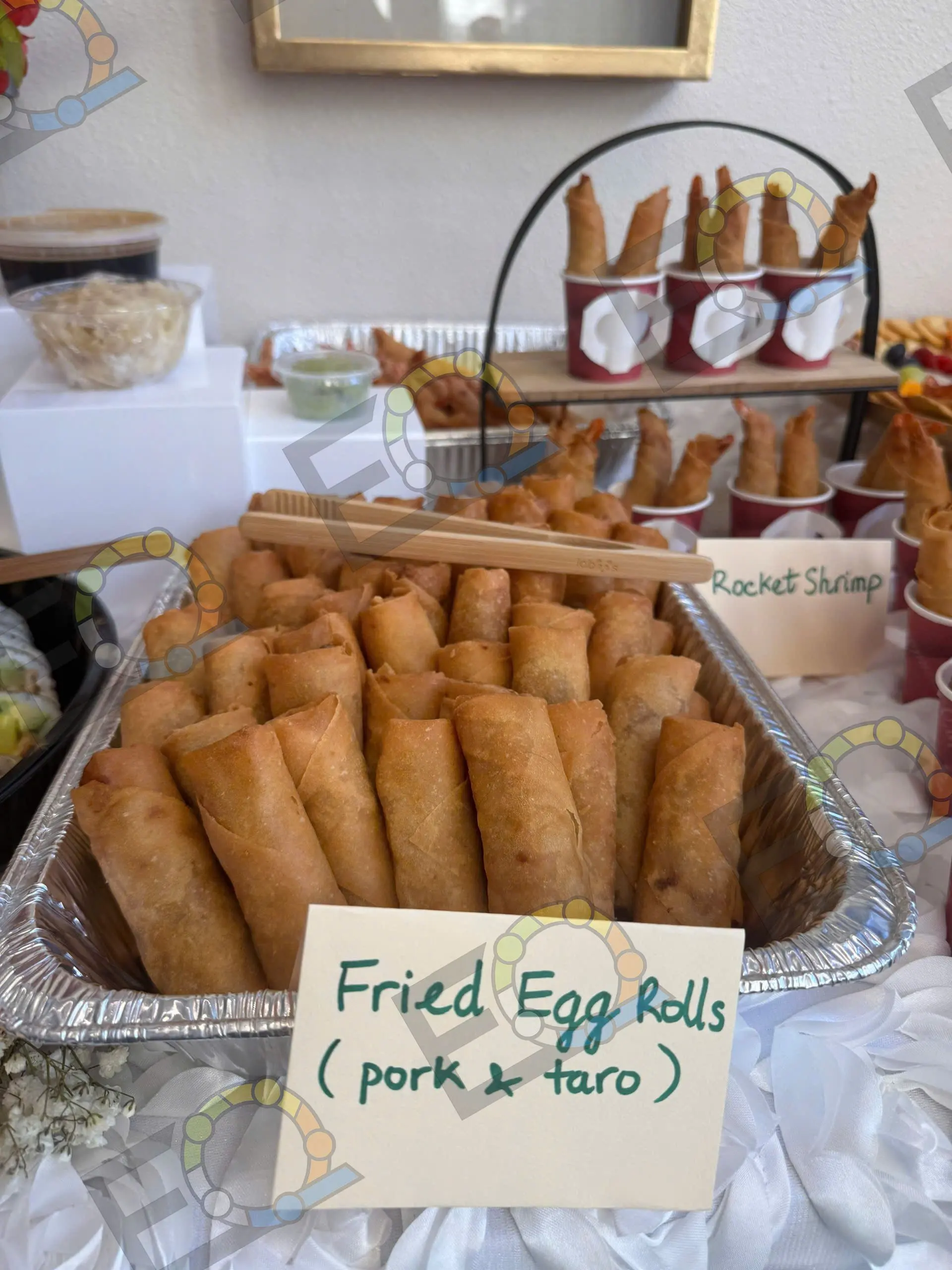 A tray of fried egg rolls labelled pork and taro