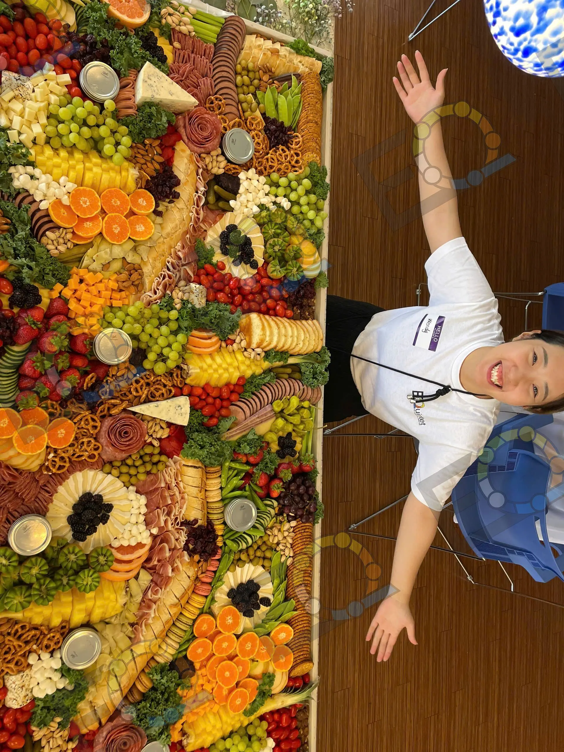 A vertical grazing wall of fruit, cheese and cured meats