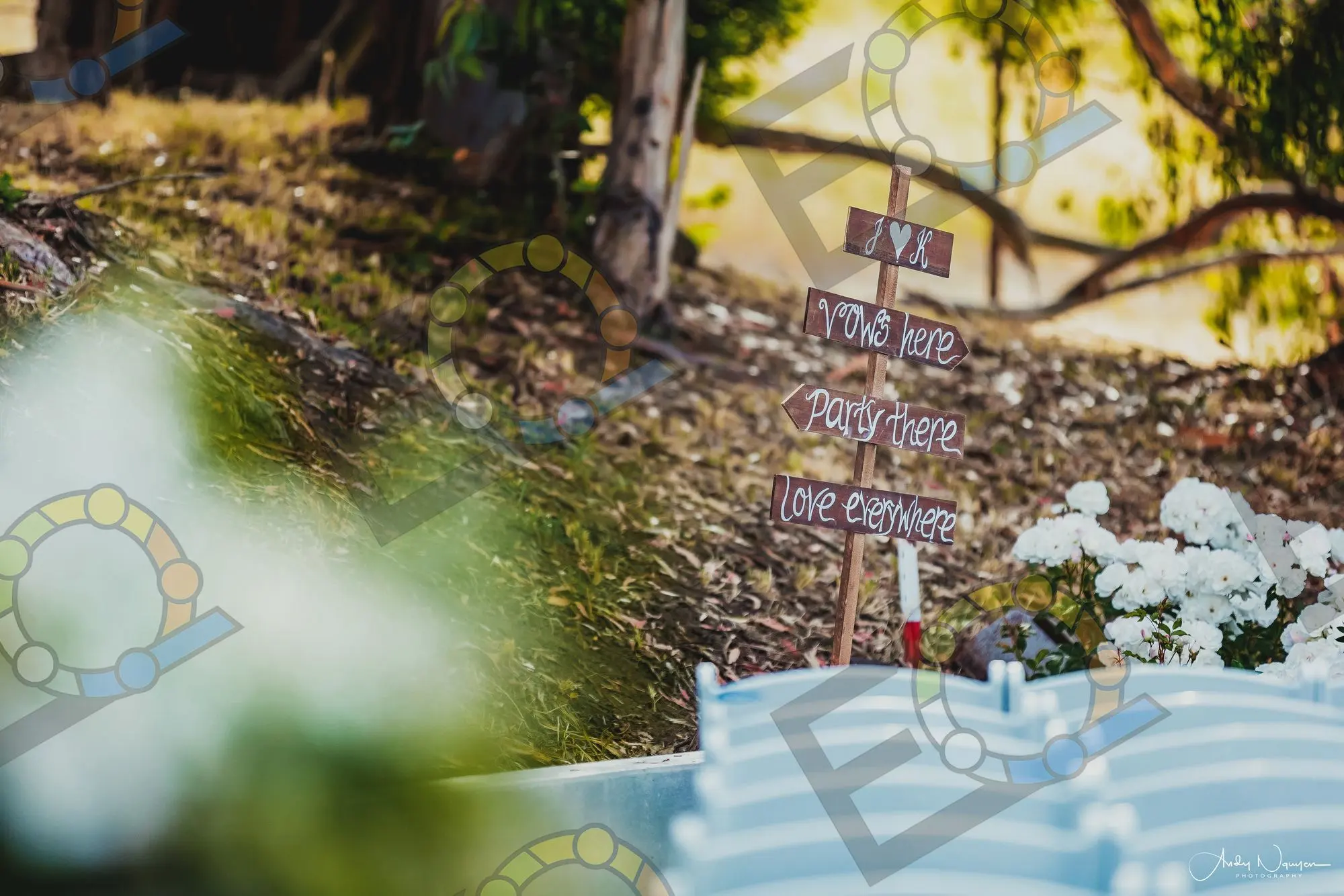Hand-painted wooden signs on a hillside above the seating