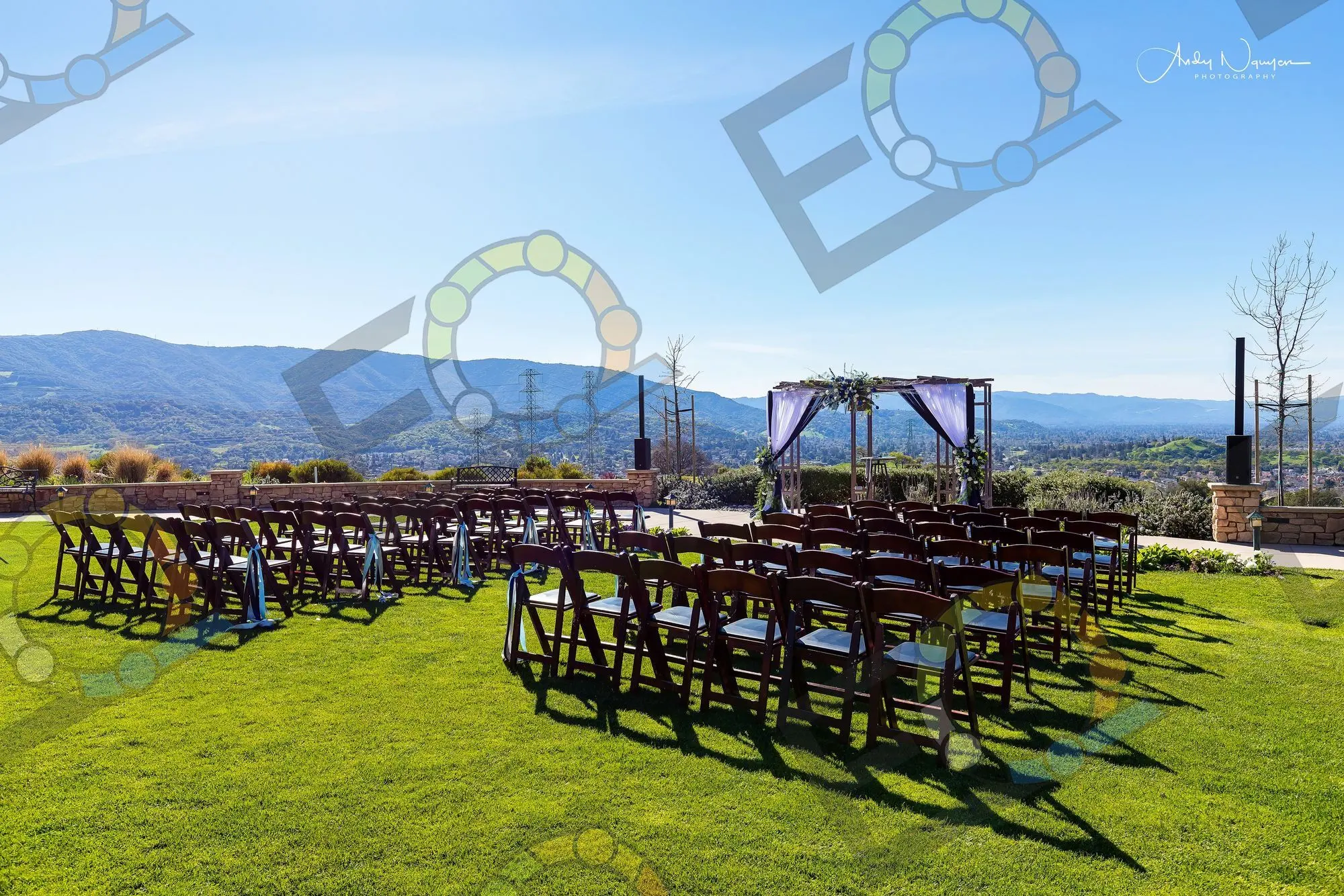 Rows of chairs facing a hilltop ceremony arch