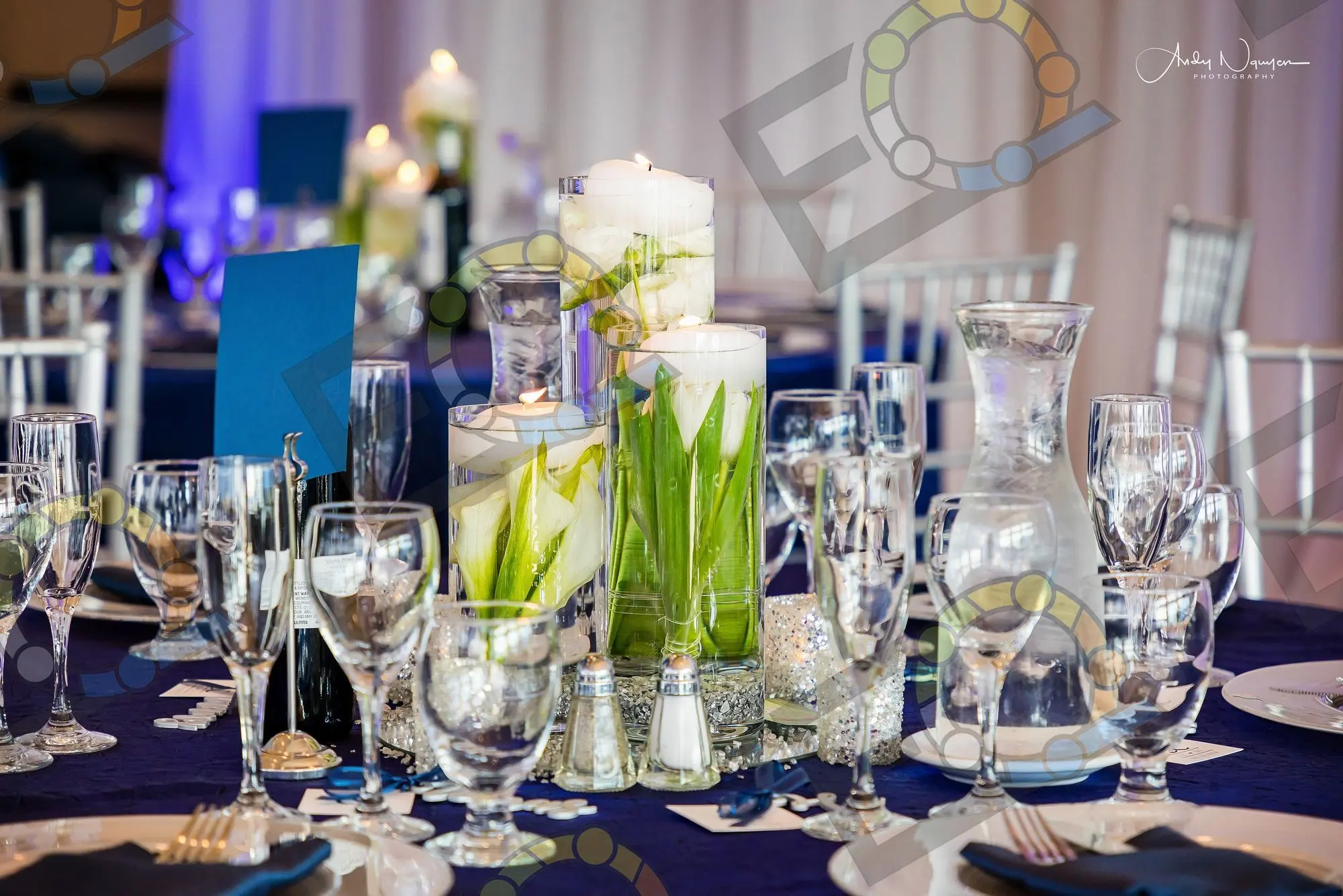 Floating candles and tulips down a navy table