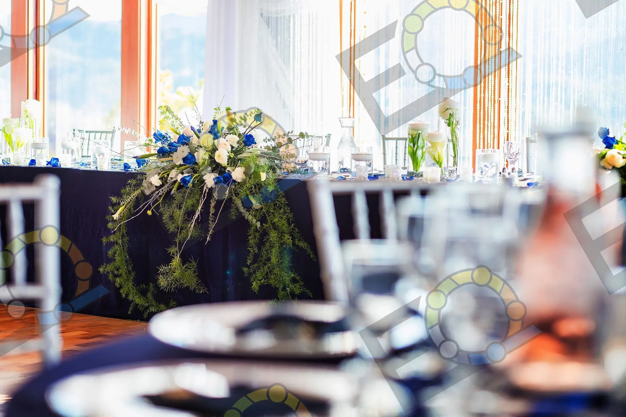 Blue and white florals on a navy table beside a window