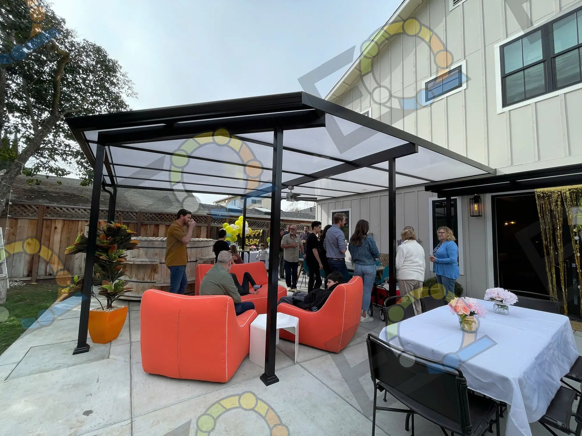 A covered patio with orange lounge chairs set for guests