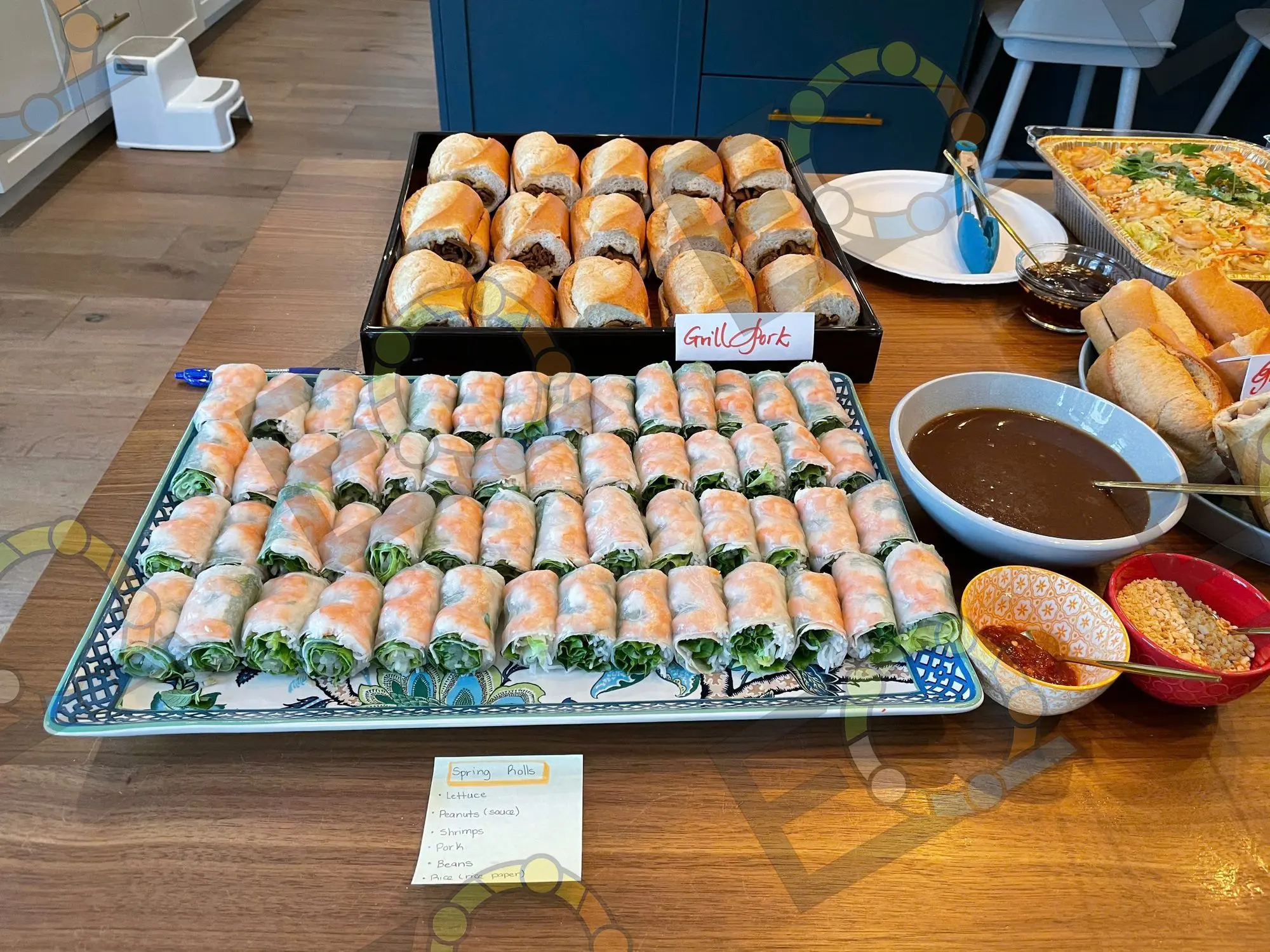 Trays of sushi and fresh spring rolls laid out for service
