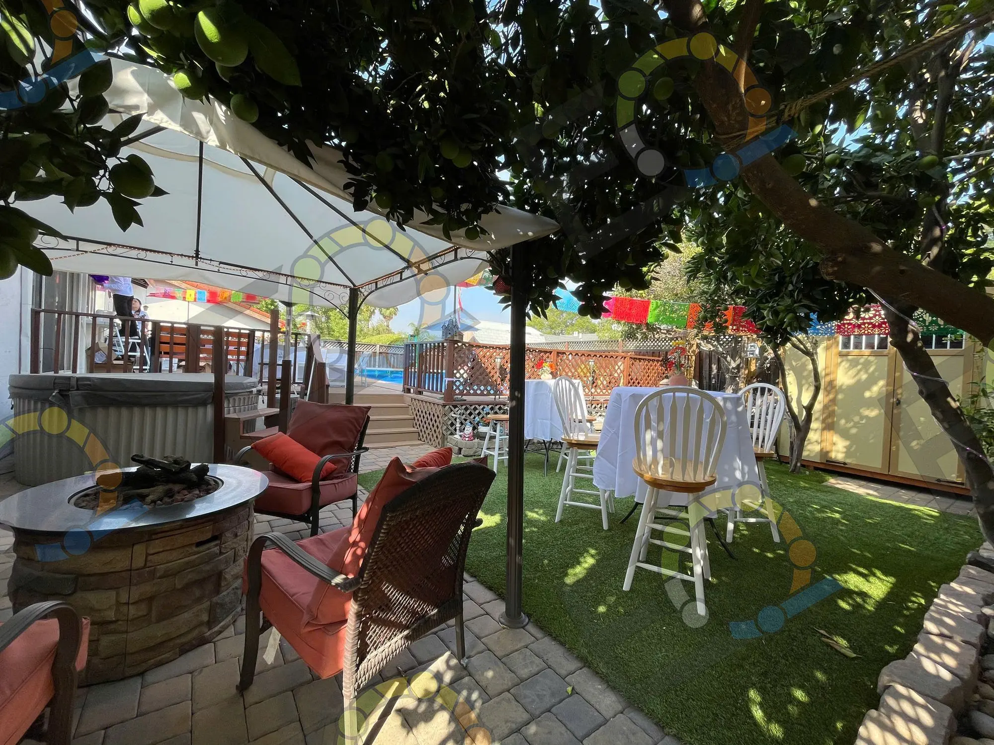 A tented lounge with sofas beside a pool