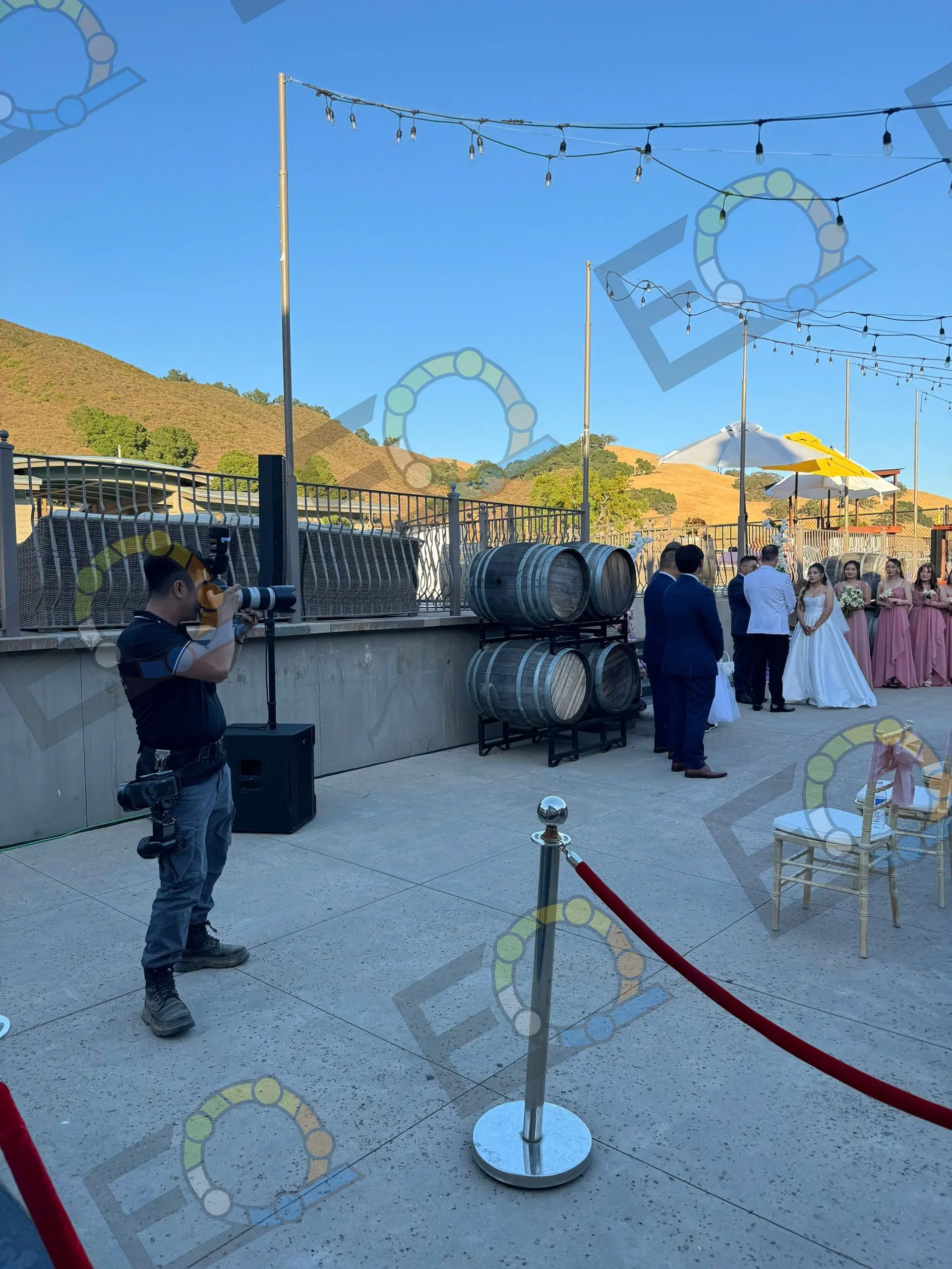 A photographer at work at an outdoor wedding