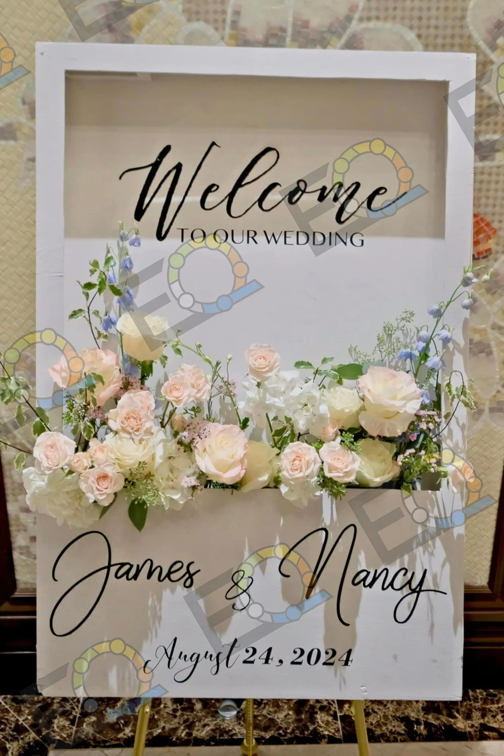 Welcome sign surrounded by blush and white florals