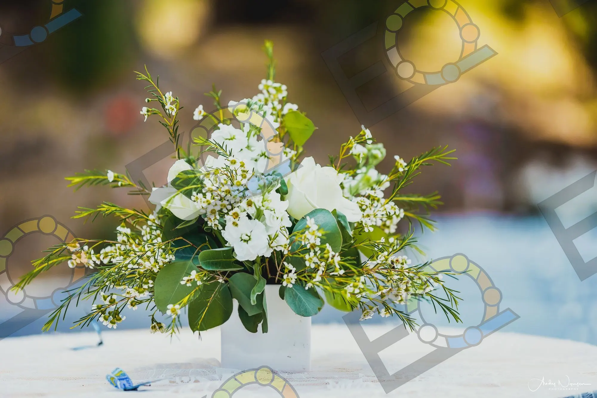 A white flower box of roses and waxflower